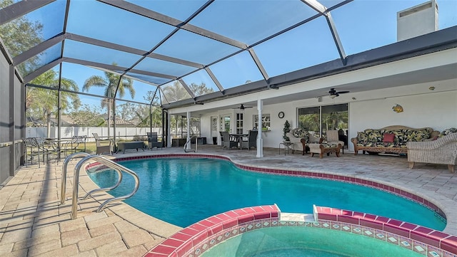 view of swimming pool featuring ceiling fan, a lanai, an outdoor living space, an in ground hot tub, and a patio