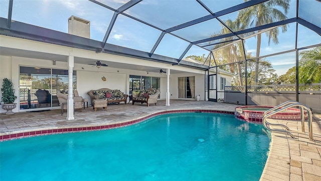 view of pool featuring an in ground hot tub, an outdoor living space, ceiling fan, glass enclosure, and a patio area