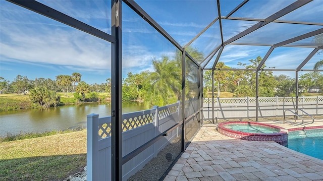 unfurnished sunroom featuring a swimming pool and a water view