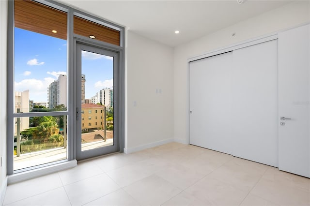 doorway to outside with light tile patterned flooring