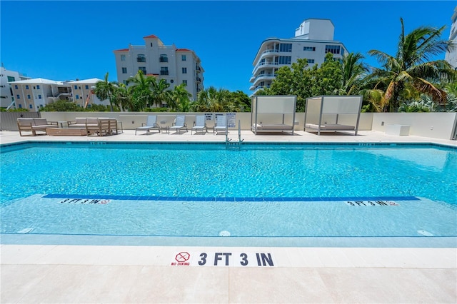 view of swimming pool featuring a patio area