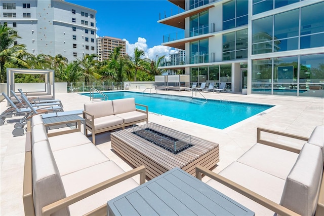 view of pool with outdoor lounge area and a patio