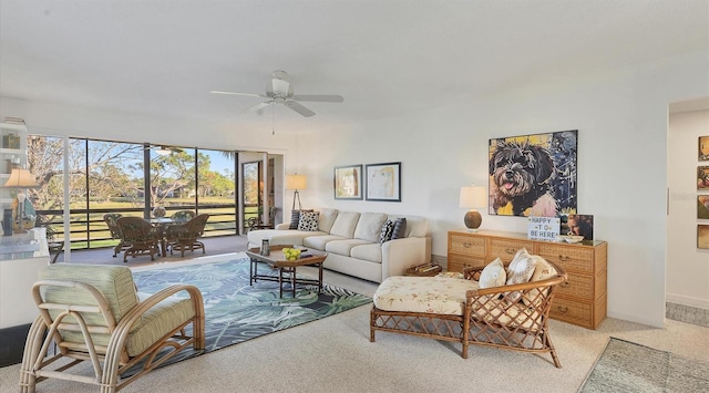 carpeted living room with ceiling fan