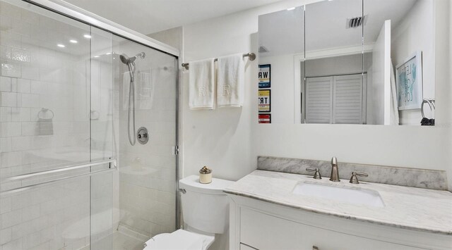 bathroom with vanity, toilet, and walk in shower