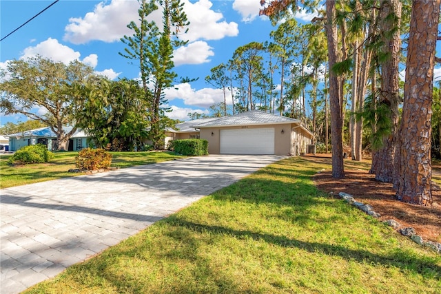 ranch-style house featuring a front yard and a garage