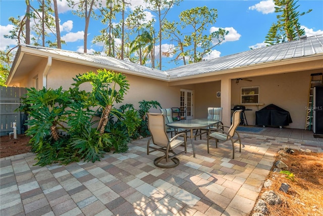 view of patio with a grill and ceiling fan