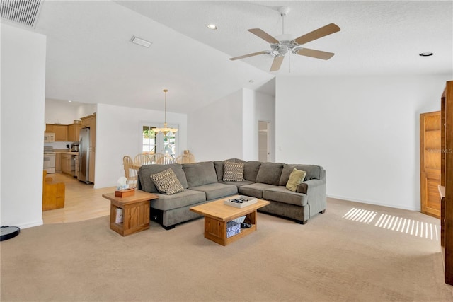 living room featuring a textured ceiling, ceiling fan, lofted ceiling, and light carpet