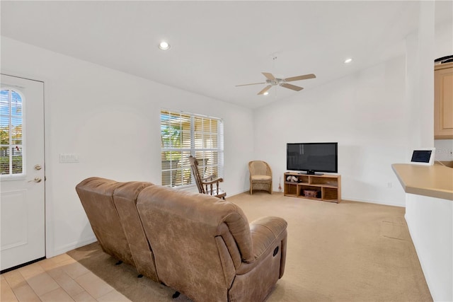 carpeted living room with ceiling fan and lofted ceiling