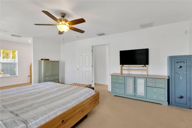 carpeted bedroom with a textured ceiling and ceiling fan