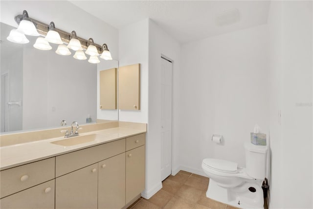 bathroom featuring tile patterned flooring, vanity, and toilet