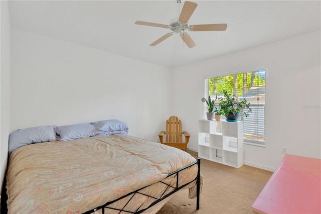 bedroom featuring light colored carpet and ceiling fan