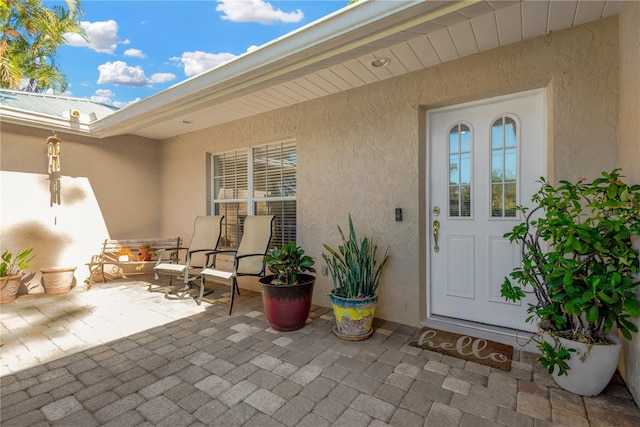 property entrance featuring a patio