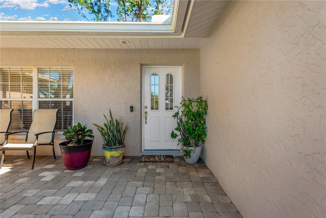 doorway to property with a patio