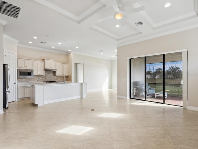 kitchen with a kitchen island with sink, ornamental molding, coffered ceiling, and appliances with stainless steel finishes