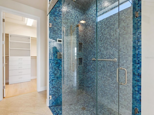 bathroom with tile patterned floors and walk in shower