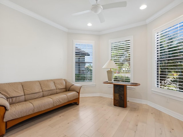 interior space with plenty of natural light, light hardwood / wood-style floors, ornamental molding, and ceiling fan