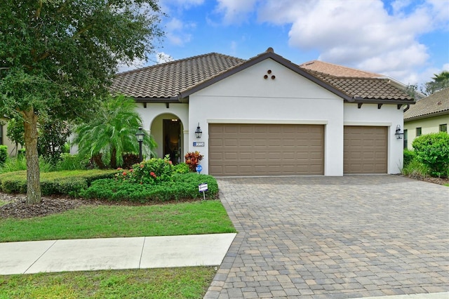 mediterranean / spanish home featuring a garage