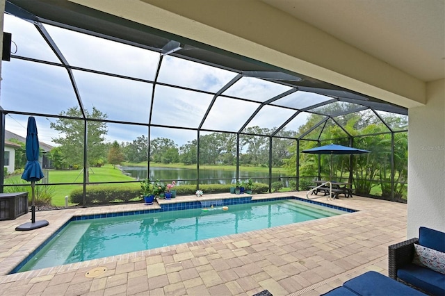 view of pool with a lanai, a patio, and a water view