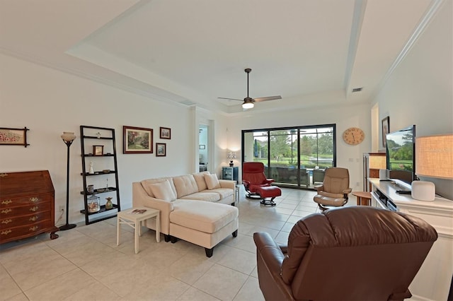 living room with light tile patterned floors, a raised ceiling, and ceiling fan