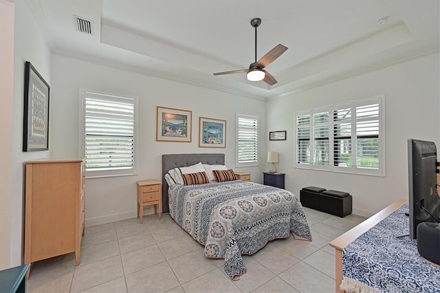 bedroom featuring light tile patterned flooring, ceiling fan, and a tray ceiling