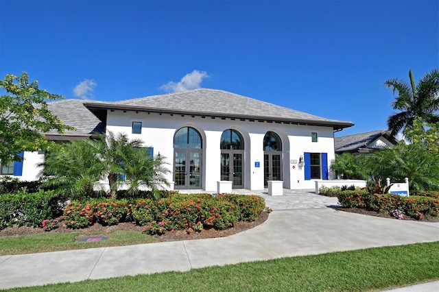 mediterranean / spanish home featuring french doors