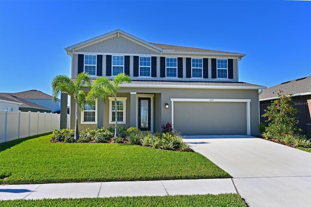 view of front of house with a front yard and a garage