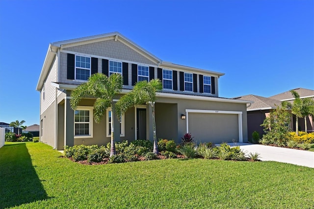 view of front of home featuring a front yard and a garage