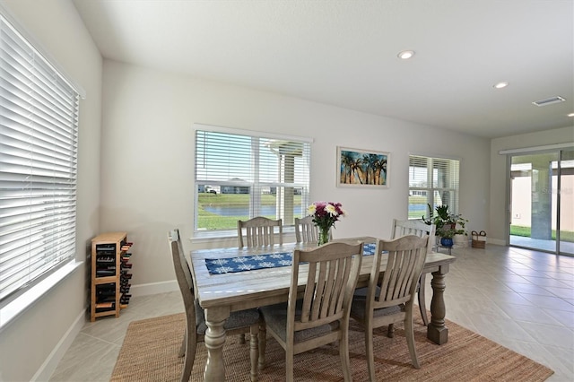 tiled dining room with a water view