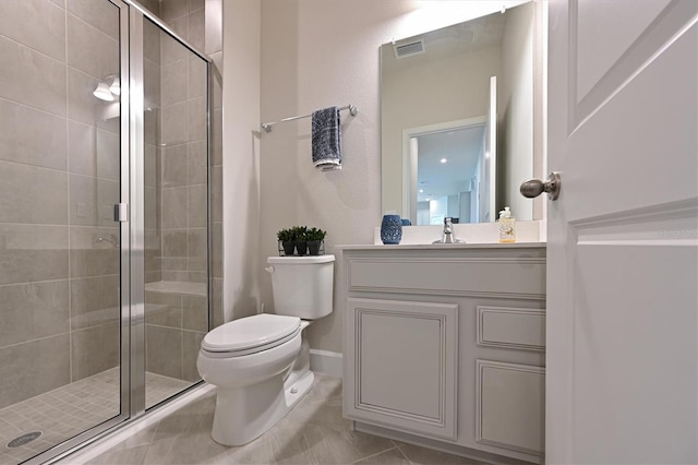 bathroom featuring walk in shower, tile patterned flooring, vanity, and toilet