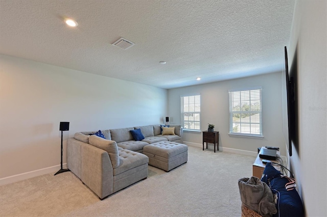 carpeted living room featuring a textured ceiling