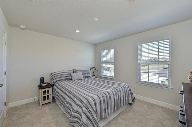 carpeted bedroom with a textured ceiling