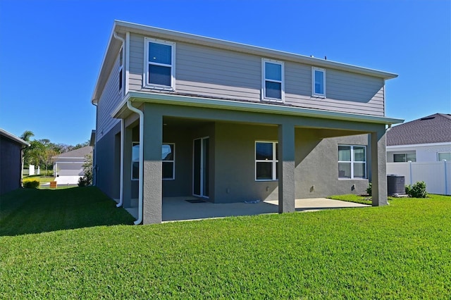 back of house with a lawn, a patio area, and central air condition unit