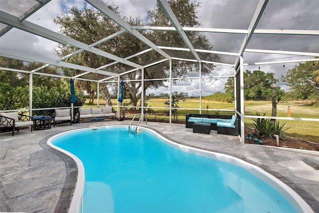 view of pool with a patio and glass enclosure