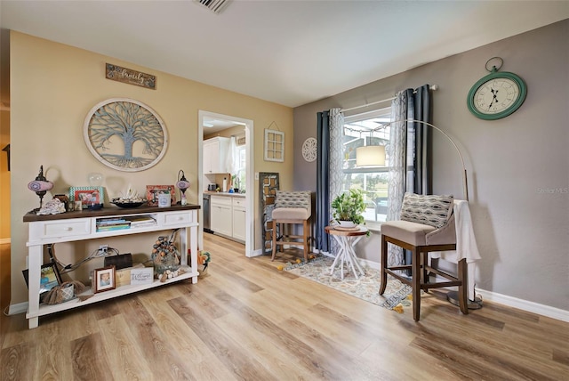 sitting room with light hardwood / wood-style flooring