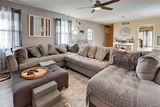 living room with ceiling fan and light hardwood / wood-style floors