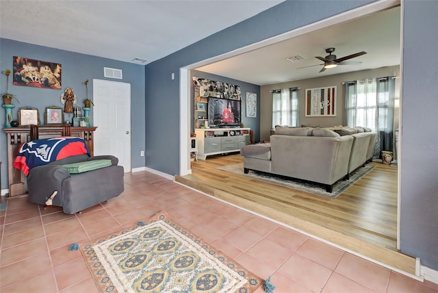 living room featuring hardwood / wood-style floors and ceiling fan