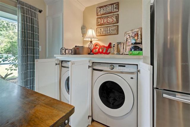 washroom with washer and dryer