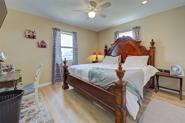 bedroom with ceiling fan and light wood-type flooring