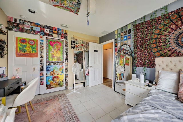 bedroom with light tile patterned floors and a closet