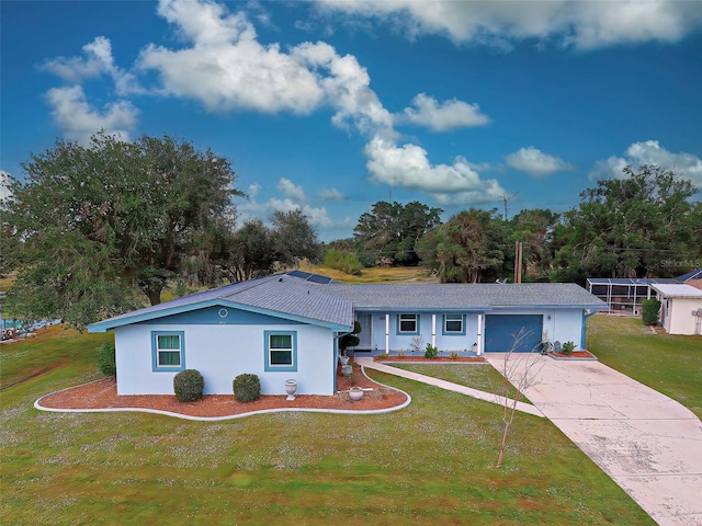 single story home featuring a front lawn and a garage