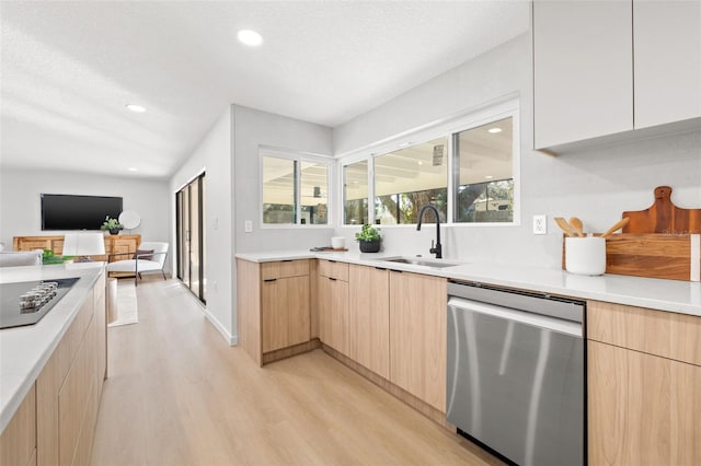 kitchen with dishwasher, light hardwood / wood-style floors, sink, and light brown cabinets