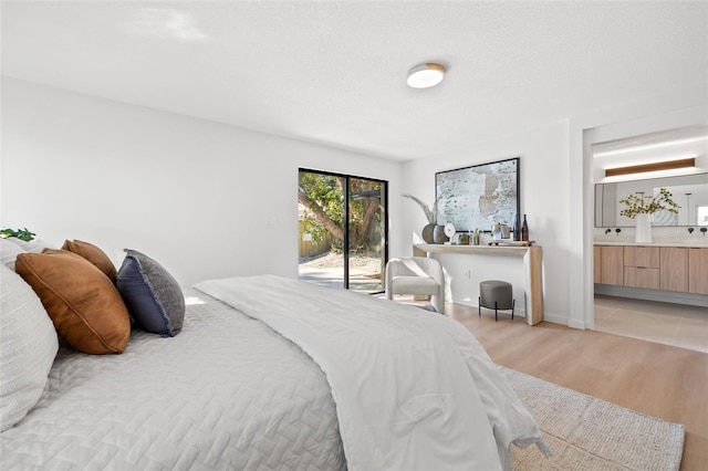 bedroom with light hardwood / wood-style floors and access to exterior