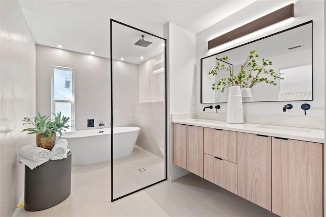 bathroom with tile patterned floors, vanity, a textured ceiling, and independent shower and bath