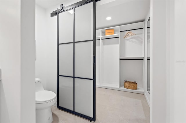 bathroom with toilet and walk in shower