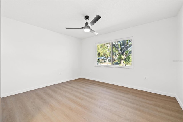 empty room featuring ceiling fan and light hardwood / wood-style flooring