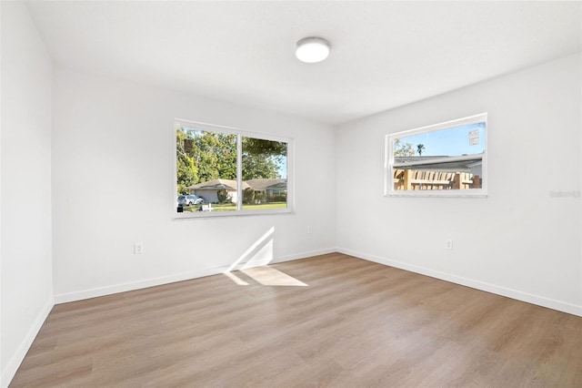 empty room with light hardwood / wood-style flooring