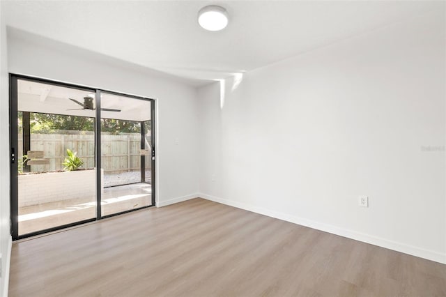 empty room with ceiling fan and light wood-type flooring