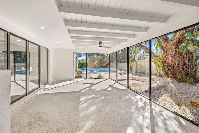 unfurnished sunroom featuring beam ceiling and ceiling fan