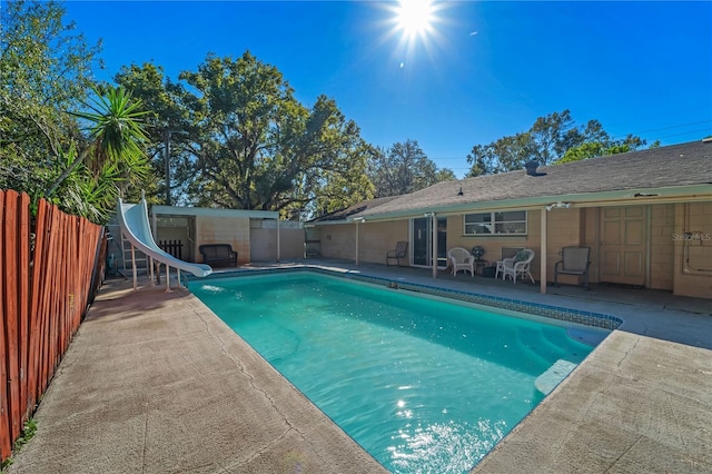 view of pool with a patio area and a water slide