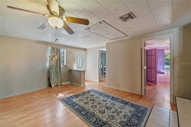 empty room with ceiling fan and wood-type flooring